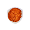 Red powder in a white bowl on a white background