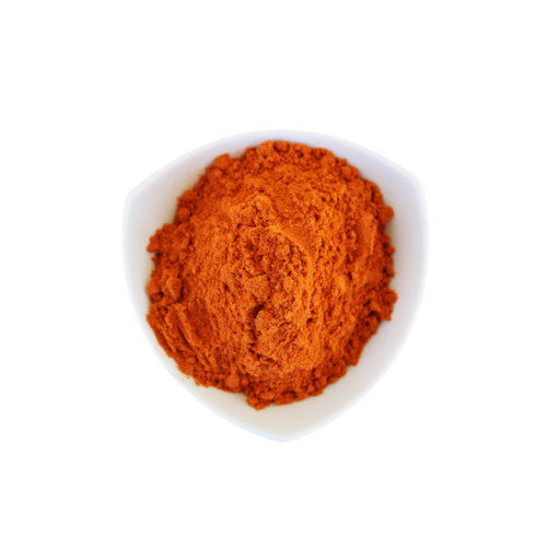 Red powder in a white bowl on a white background