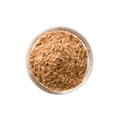Brown powder in a clear glass container on a white background