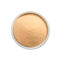 White bowl filled with light brown powder on a white background