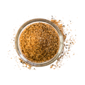 Glass jar filled with brown spice blend on a white background