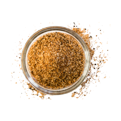 Glass jar filled with brown spice blend on a white background